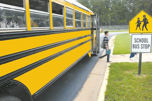 student exiting yellow school bus